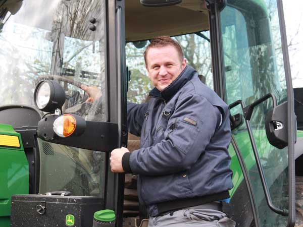 Close-up of machinery and glassware in an industrial workshop setting, featuring tools and equipment.